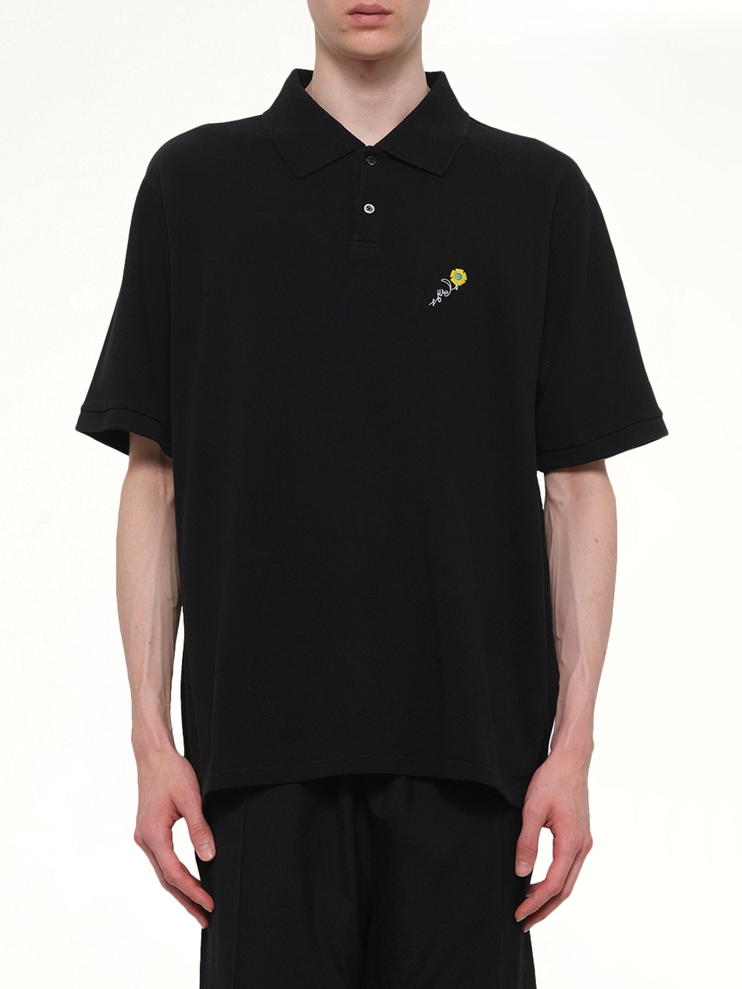 Image of a model wearing Tops. Product name - S/S Pique Polo in Black colour by brand - VOWELS