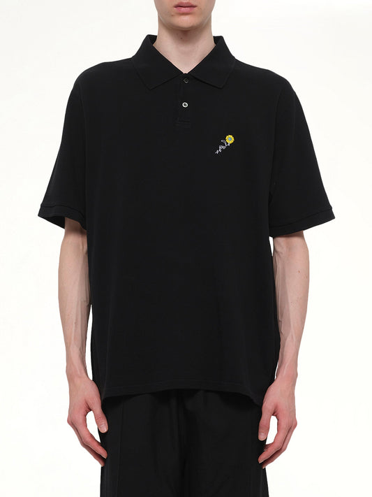 Image of a model wearing Tops. Product name - S/S Pique Polo in Black colour by brand - VOWELS