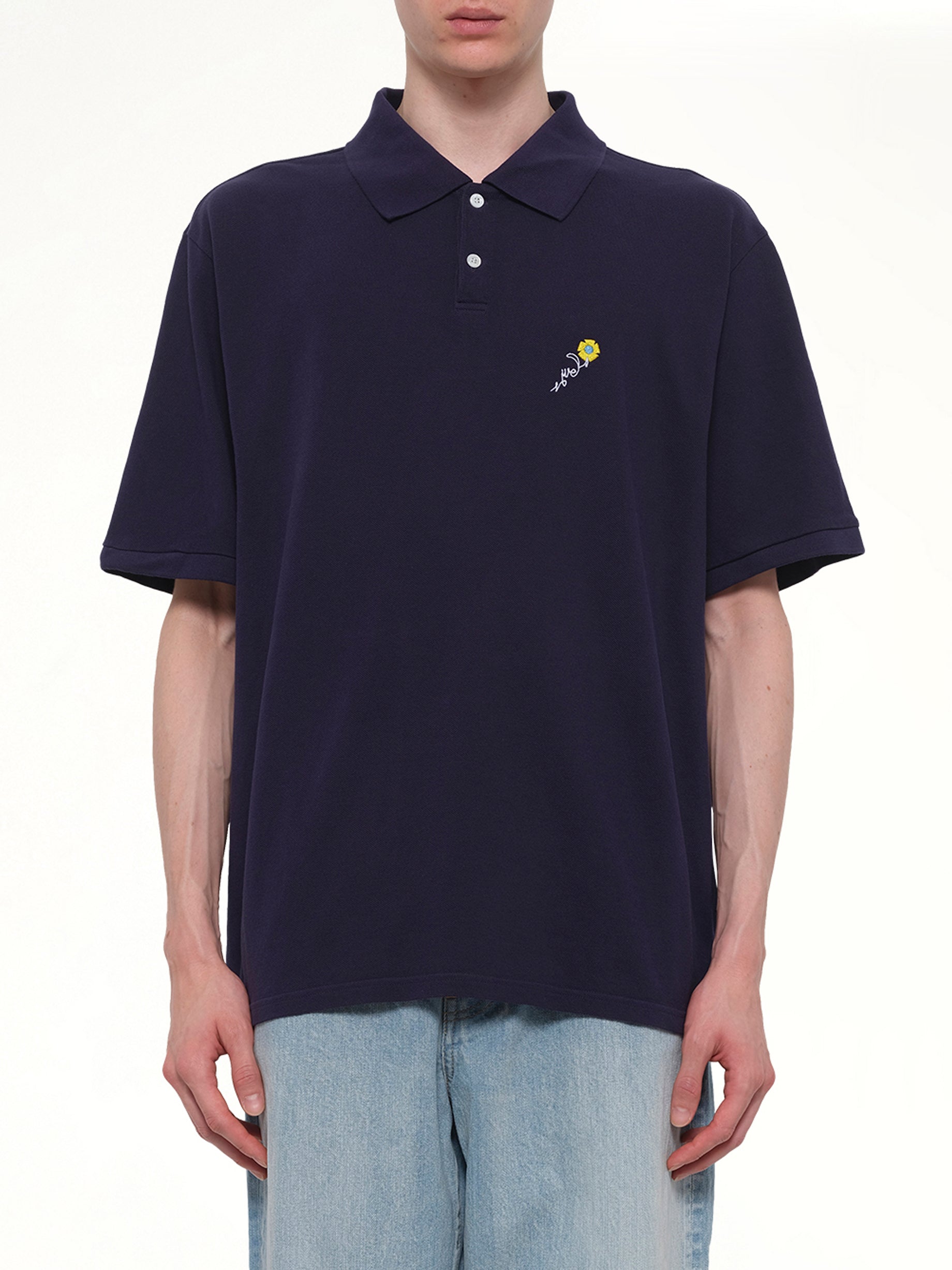 Image of a model wearing Tops. Product name - S/S Pique Polo in Navy colour by brand - VOWELS