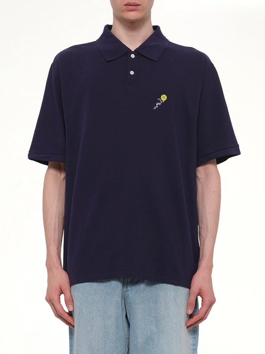 Image of a model wearing Tops. Product name - S/S Pique Polo in Navy colour by brand - VOWELS