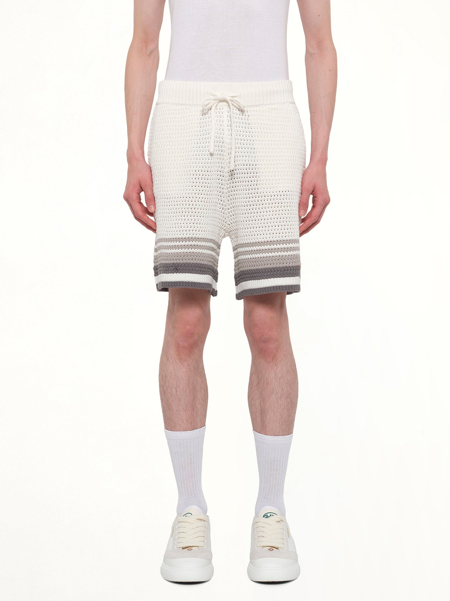 Image of a model wearing Shorts. Product name - Crochet Shorts in White colour by brand - CASABLANCA