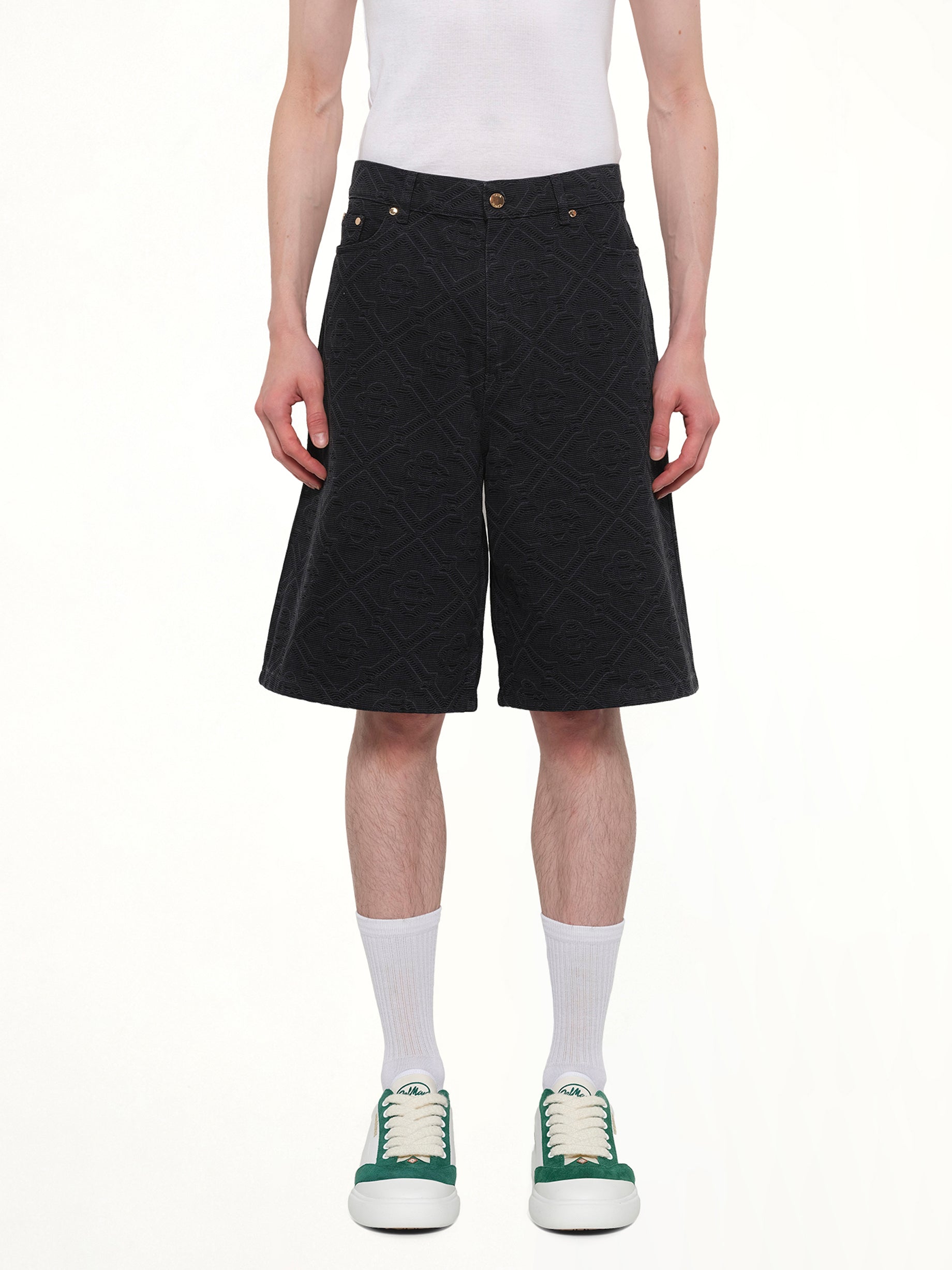 Image of a model wearing Shorts. Product name - Laser Monogram Denim Shorts in Black colour by brand - CASABLANCA