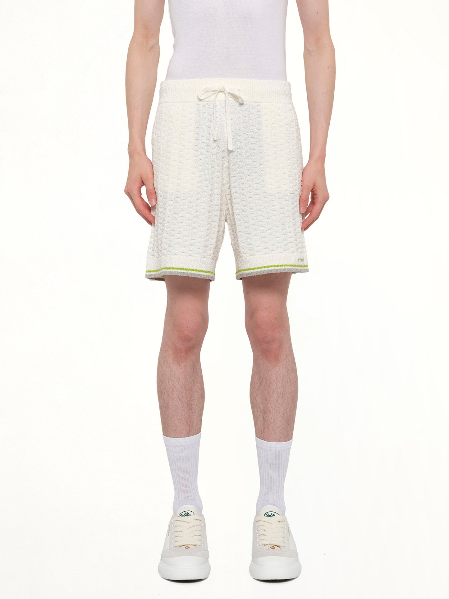 Image of a model wearing Shorts. Product name - Tennis Boucle Shorts in White colour by brand - CASABLANCA