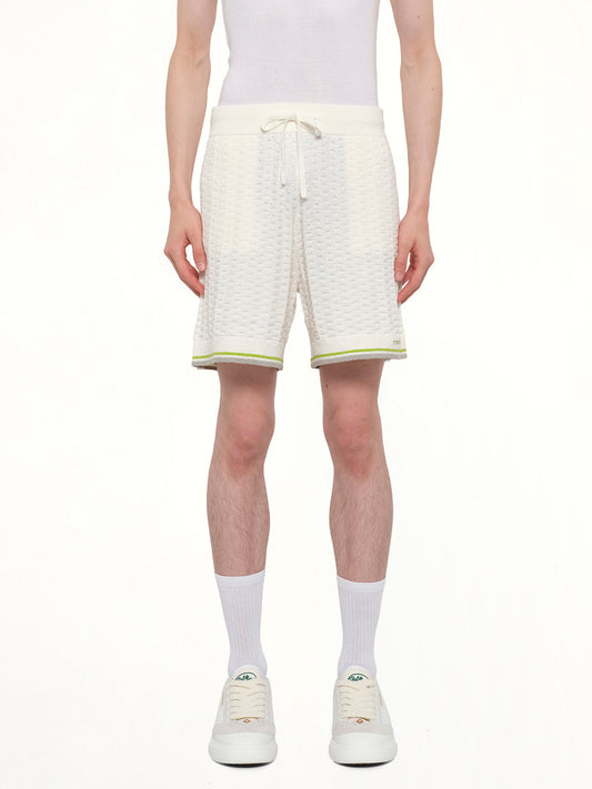 Image of a model wearing Shorts. Product name - Tennis Boucle Shorts in White colour by brand - CASABLANCA