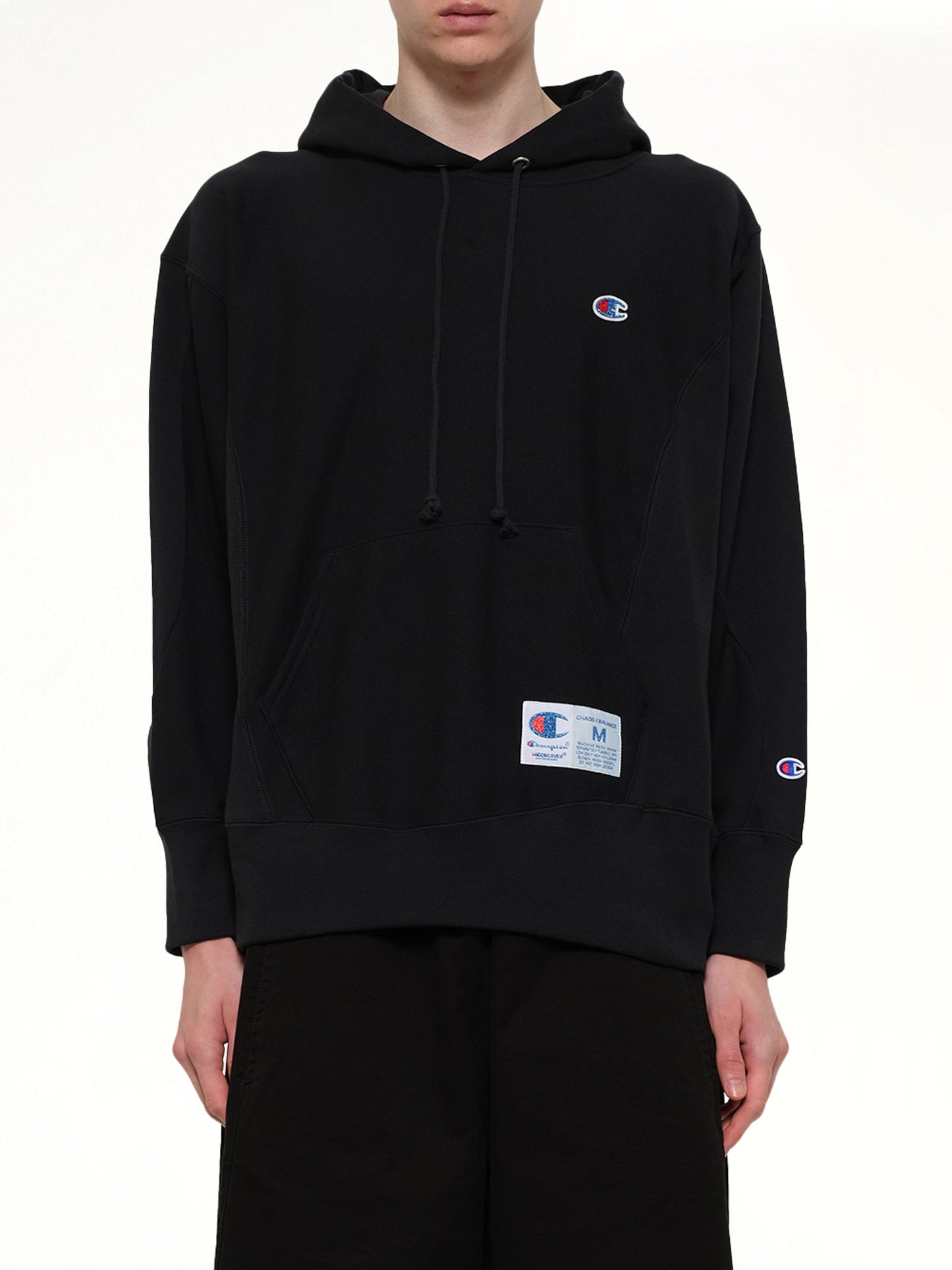 Image of a model wearing Outerwear. Product name - Champion x UC Hoodie in Black colour by brand - UNDERCOVER