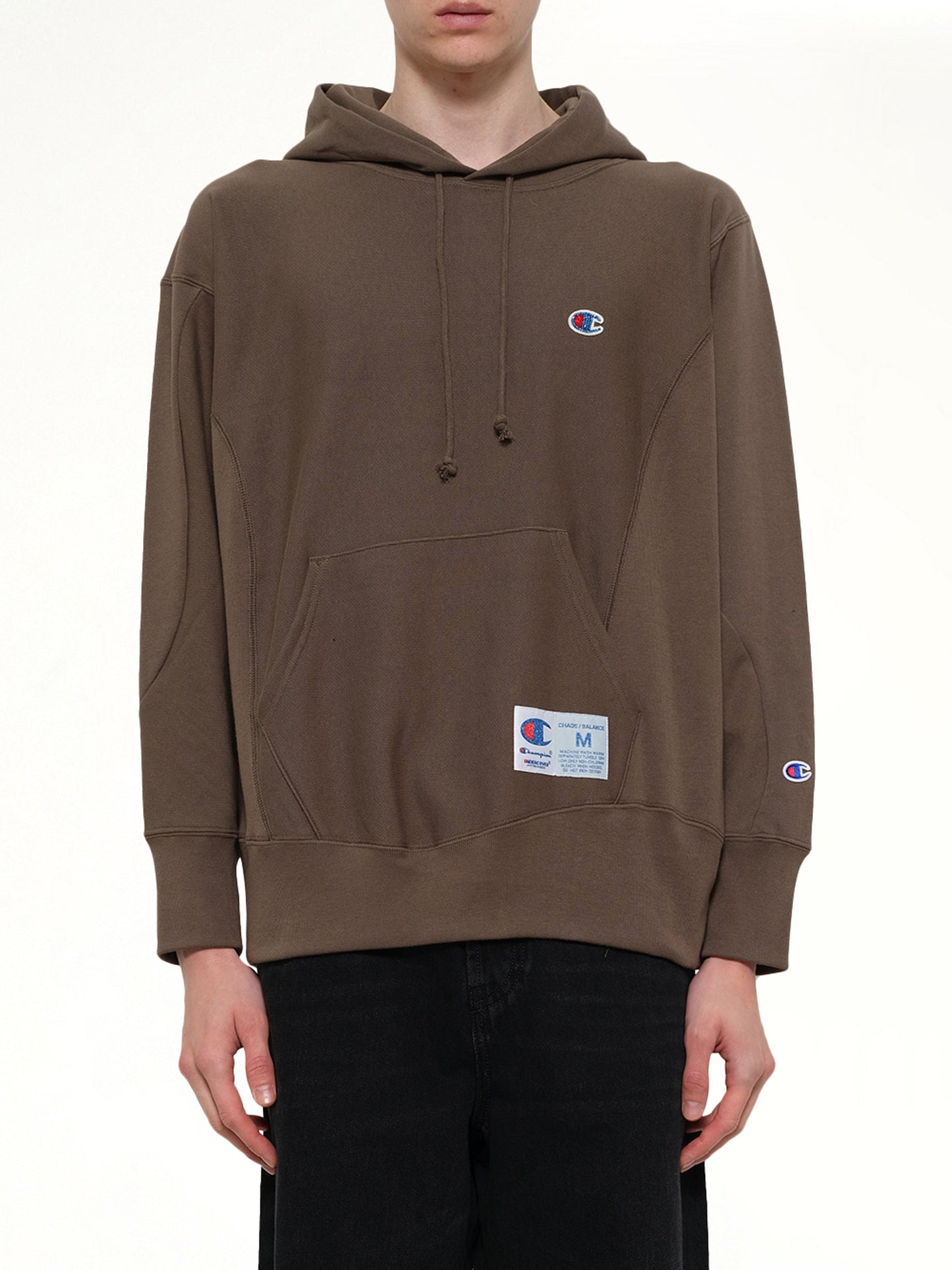 Image of a model wearing Outerwear. Product name - Champion x UC Hoodie in Khaki colour by brand - UNDERCOVER