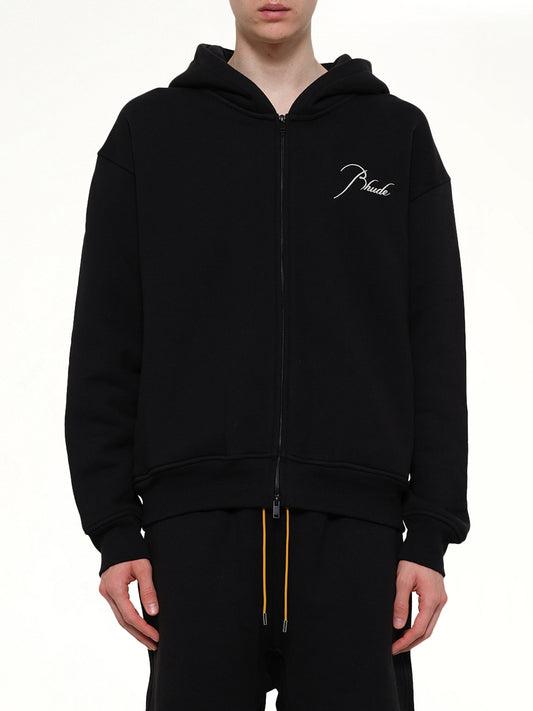 Image of a model wearing Outerwear. Product name - Classique Zip Up Hoodie in Black colour by brand - RHUDE