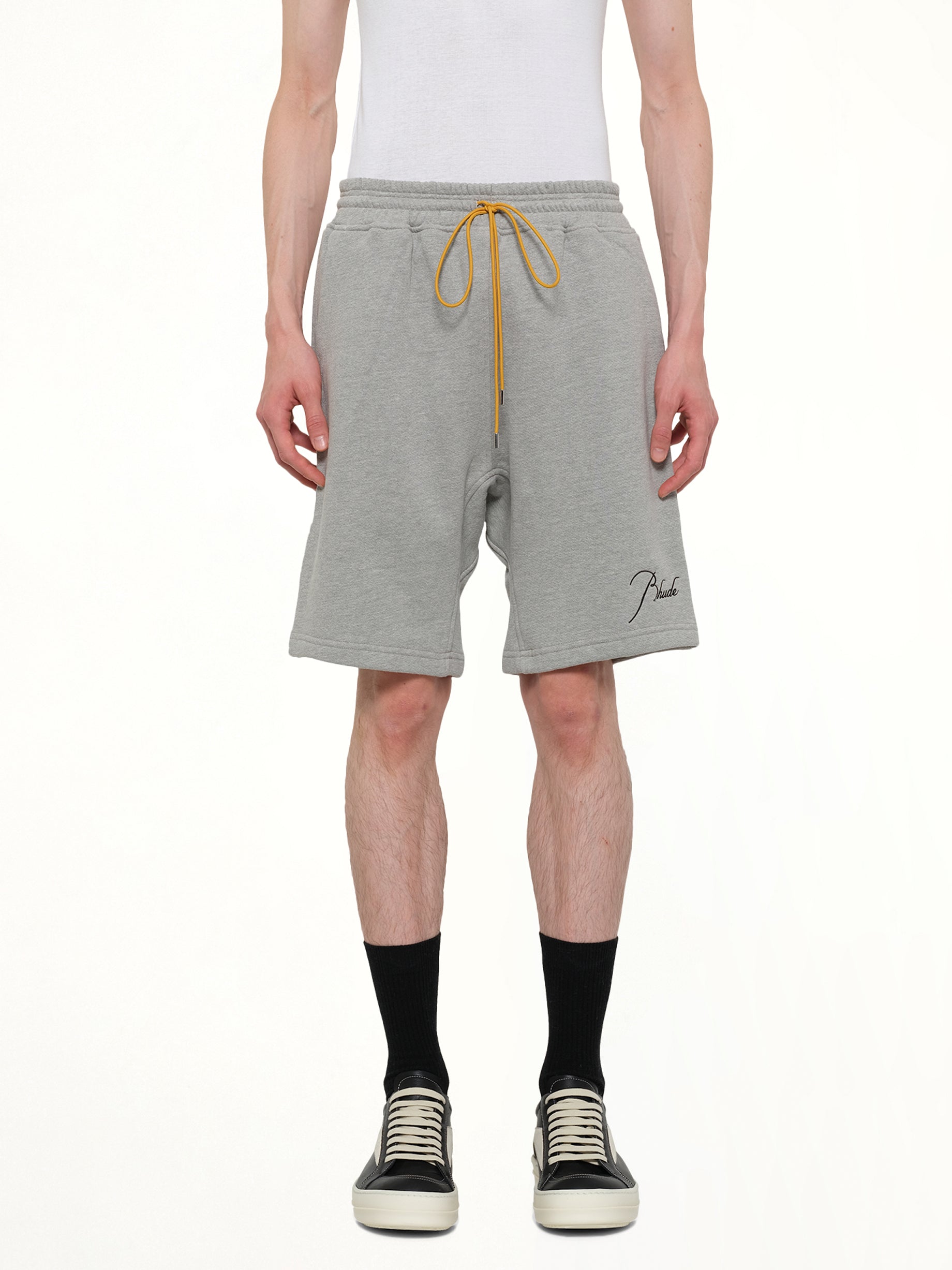 Image of a model wearing Shorts. Product name - Classique Sweatshort in Grey colour by brand - RHUDE