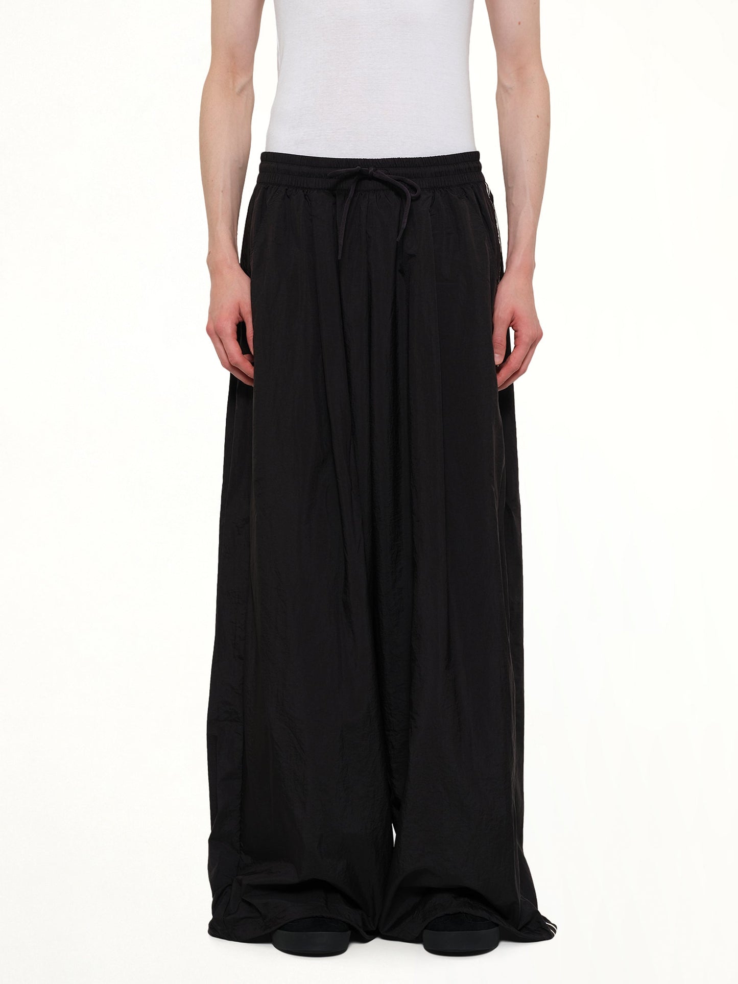 Image of a model wearing Pants. Product name - Reconstructed 3S Pants in Black colour by brand - Y-3