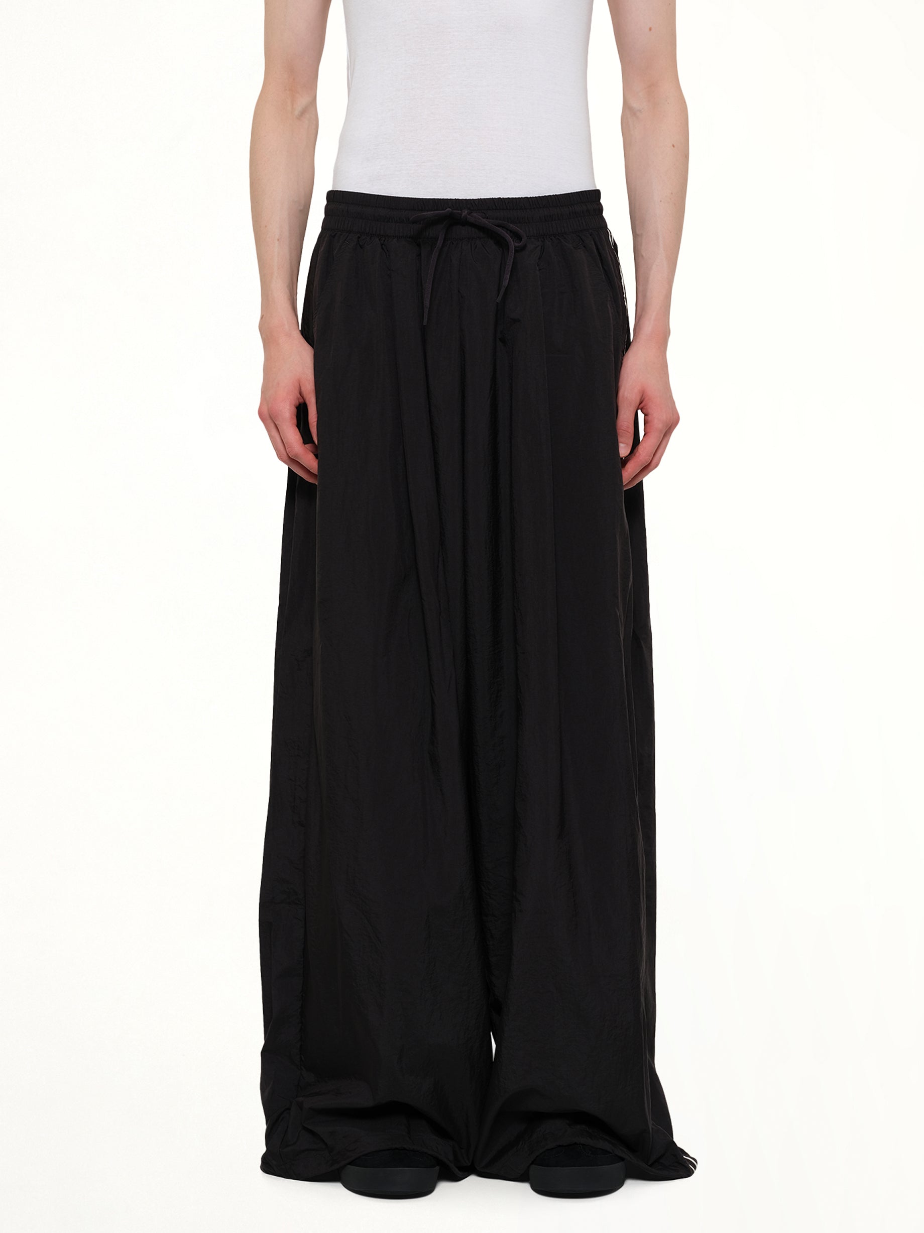 Image of a model wearing Pants. Product name - Reconstructed 3S Pants in Black colour by brand - Y-3