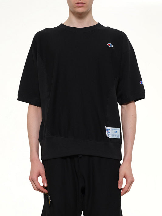 Image of a model wearing Outerwear. Product name - Champion x UC Sweat Top in Black colour by brand - UNDERCOVER