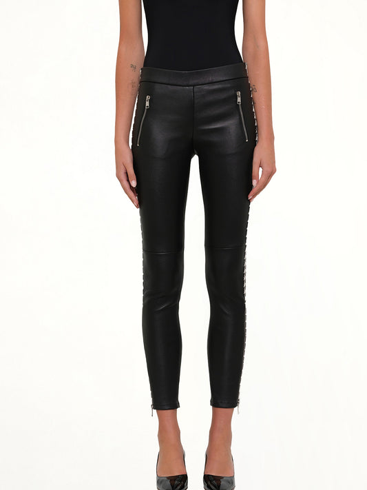 Image of a model wearing Pants. Product name - Leather Leggings in Black colour by brand - ALEXANDER MCQUEEN