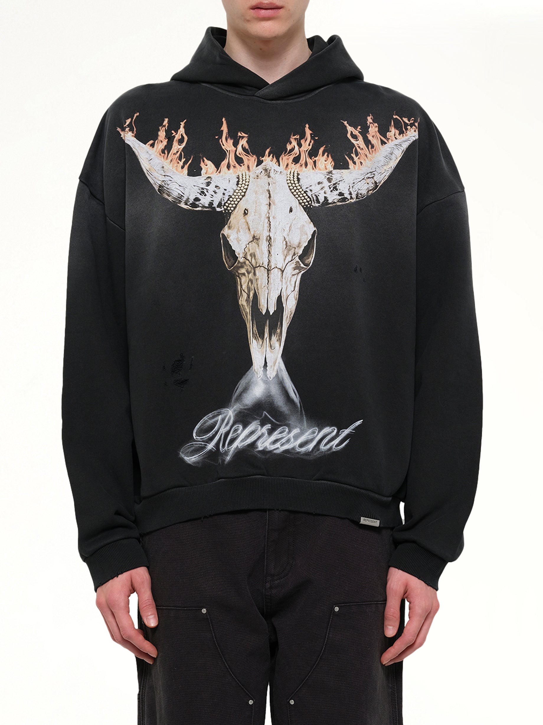 Image of a model wearing Outerwear. Product name - British Cowboys Hoodie in Black colour by brand - REPRESENT
