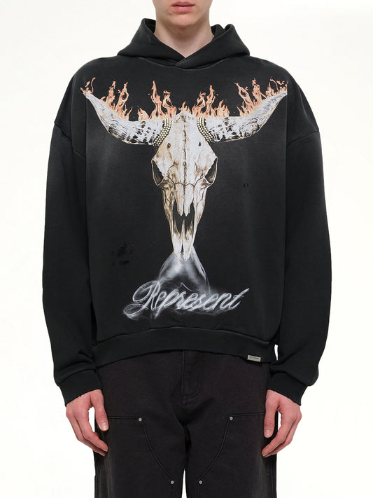Image of a model wearing Outerwear. Product name - British Cowboys Hoodie in Black colour by brand - REPRESENT