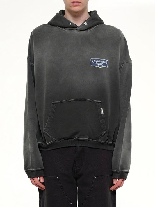 Image of a model wearing Outerwear. Product name - Nothing Faster Hoodie in Black colour by brand - REPRESENT