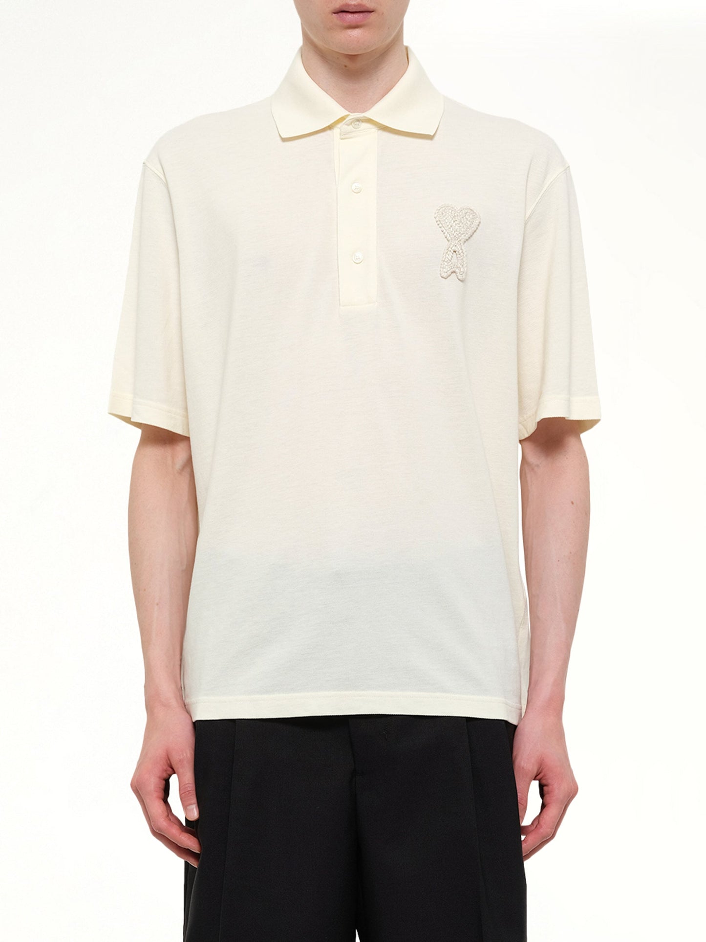 Image of a model wearing Tops. Product name - Knitted ADC Boxy Polo in White colour by brand - AMI PARIS
