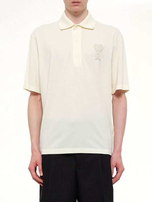 Image of a model wearing Tops. Product name - Knitted ADC Boxy Polo in White colour by brand - AMI PARIS