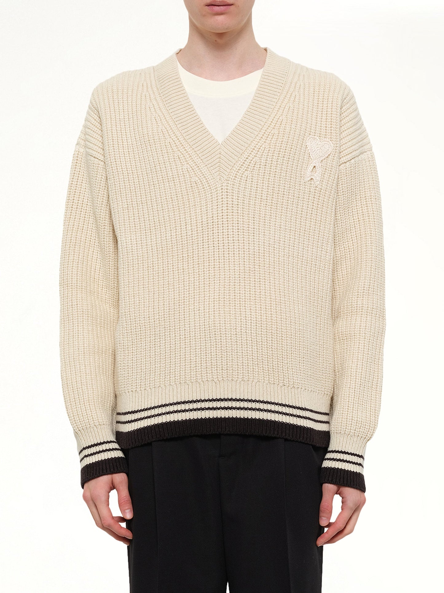 Image of a model wearing Outerwear. Product name - Ami De Coeur V Neck College Sweater in White colour by brand - AMI PARIS
