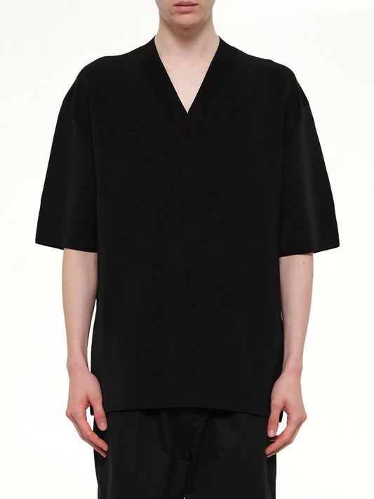 Image of a model wearing Outerwear. Product name - Short Sleeve V-Neck Sweater in Black colour by brand - AMI PARIS