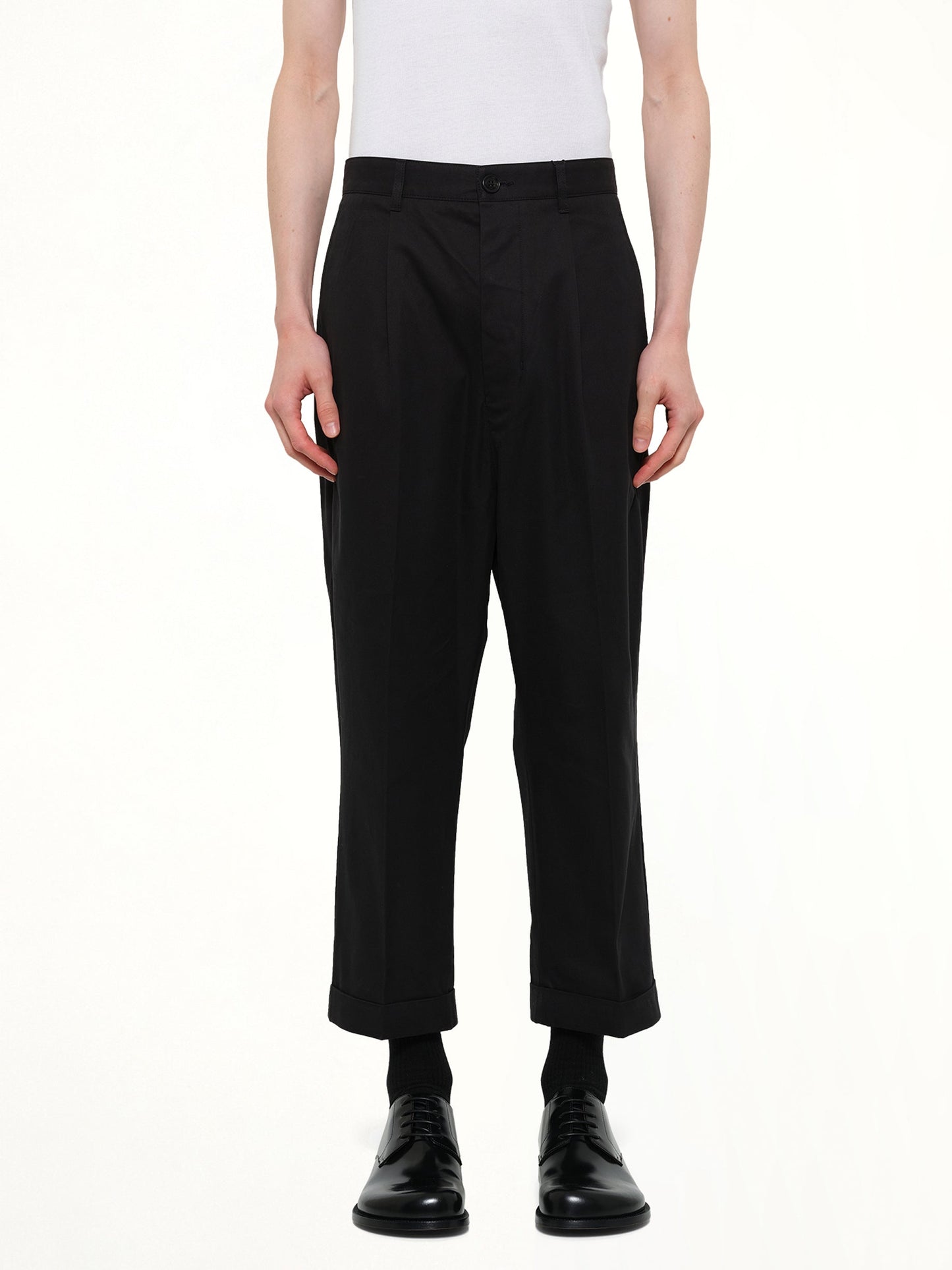 Image of a model wearing Pants. Product name - Carrot Oversized Trouser in Black colour by brand - AMI PARIS