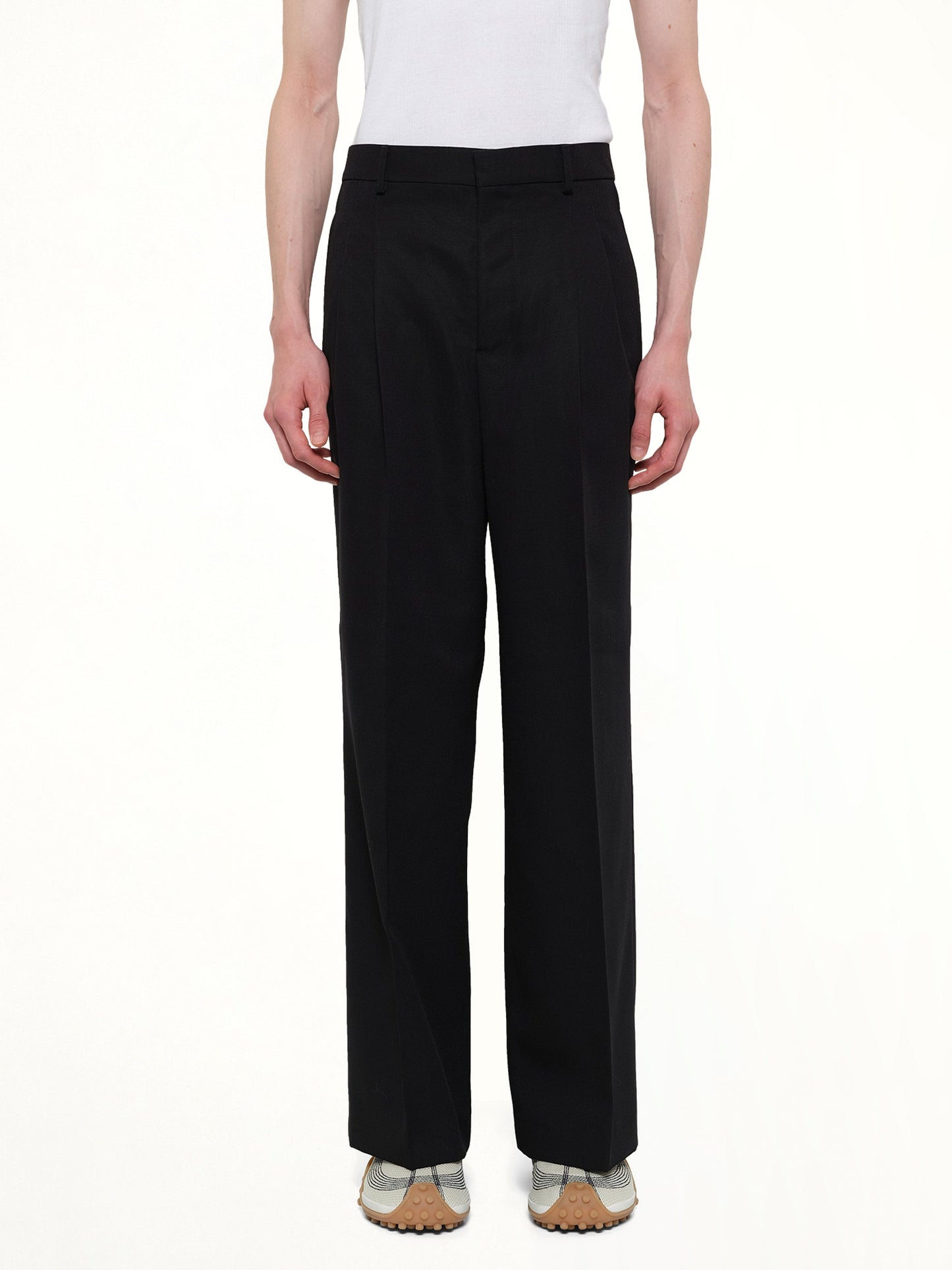 Image of a model wearing Pants. Product name - Low Waist Wide Trouser in Black colour by brand - AMI PARIS