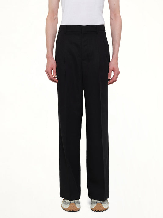 Image of a model wearing Pants. Product name - Low Waist Wide Trouser in Black colour by brand - AMI PARIS