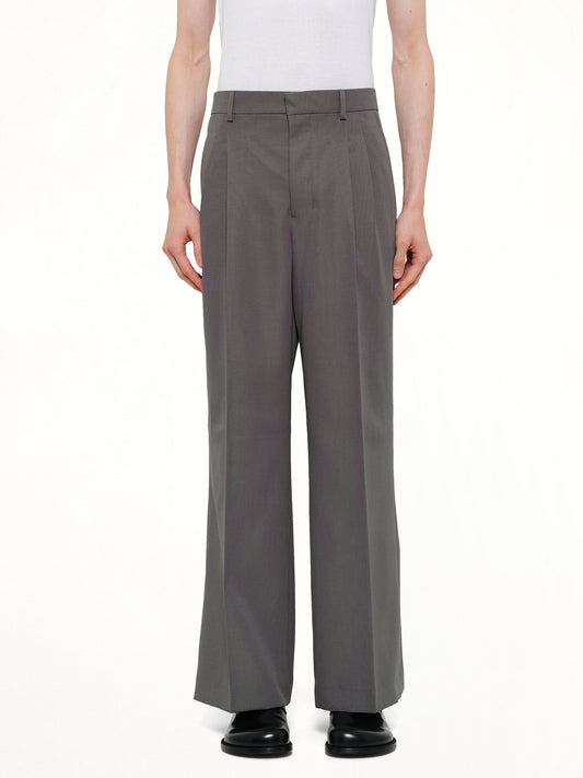 Image of a model wearing Pants. Product name - Low Waist Wide Trouser in Grey colour by brand - AMI PARIS