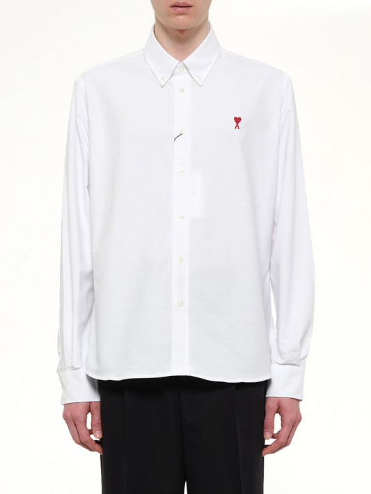 Image of a model wearing Tops. Product name - Embroidered ADC Long Sleeve Shirt in White colour by brand - AMI PARIS