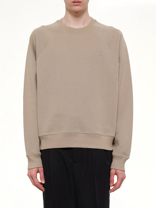Image of a model wearing Outerwear. Product name - Small Embossed ADC Sweatshirt in Beige colour by brand - AMI PARIS