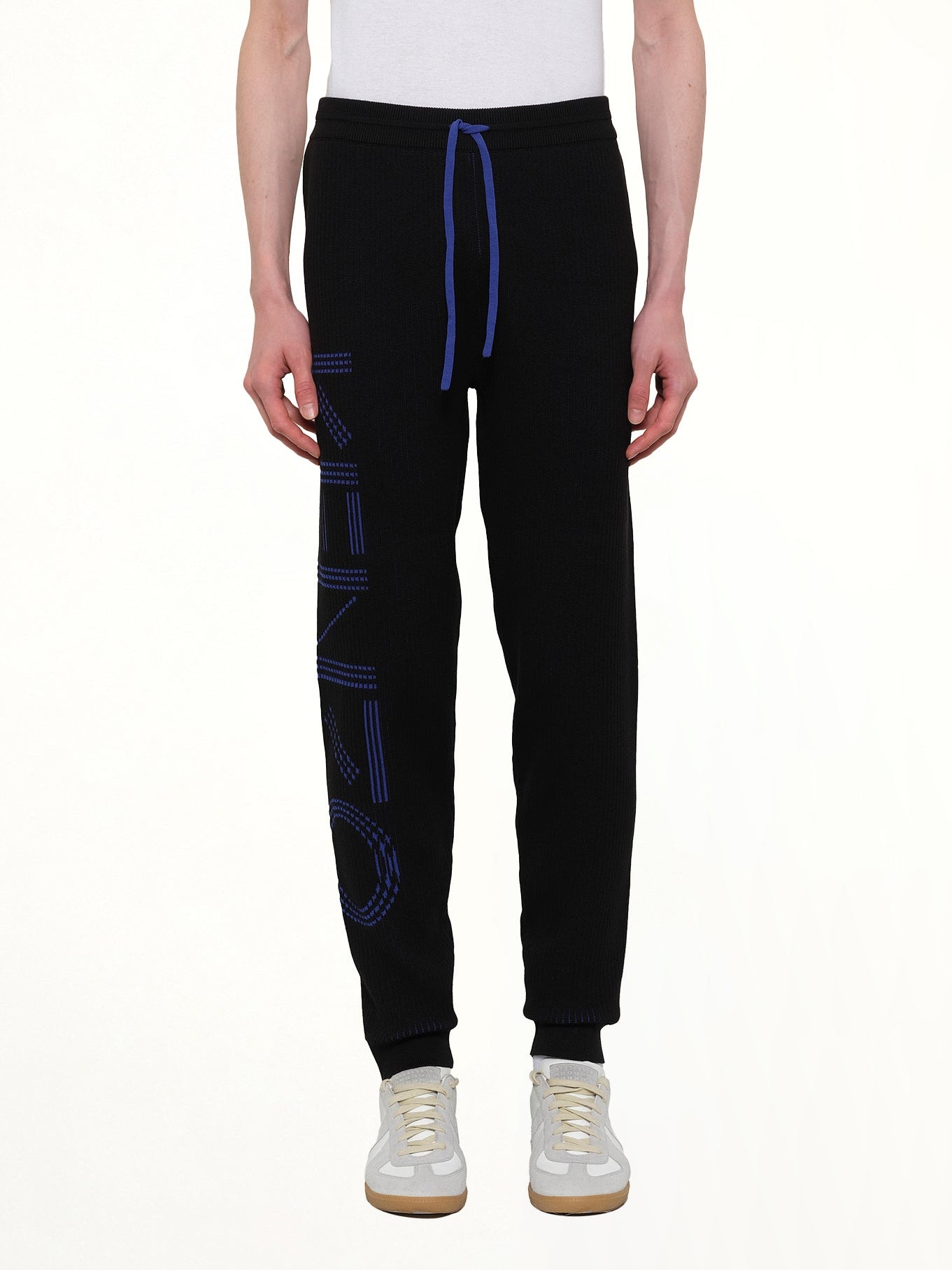 Image of a model wearing Pants. Product name - Knitted Track Pants in Black colour by brand - KENZO