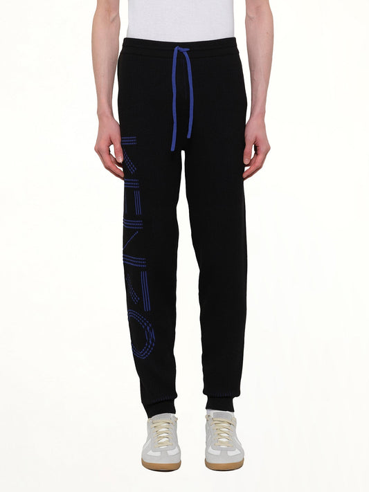 Image of a model wearing Pants. Product name - Knitted Track Pants in Black colour by brand - KENZO
