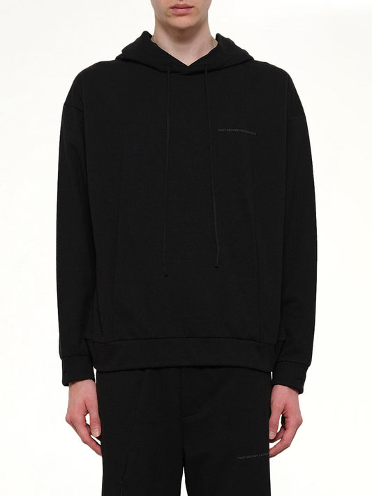 Image of a model wearing Outerwear. Product name - Work Hoodie (Archive) in Black colour by brand - POST ARCHIVE FACTION