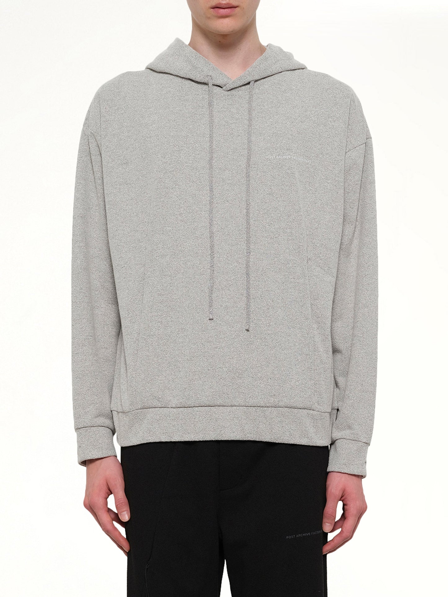 Image of a model wearing Outerwear. Product name - Work Hoodie (Archive) in Grey colour by brand - POST ARCHIVE FACTION