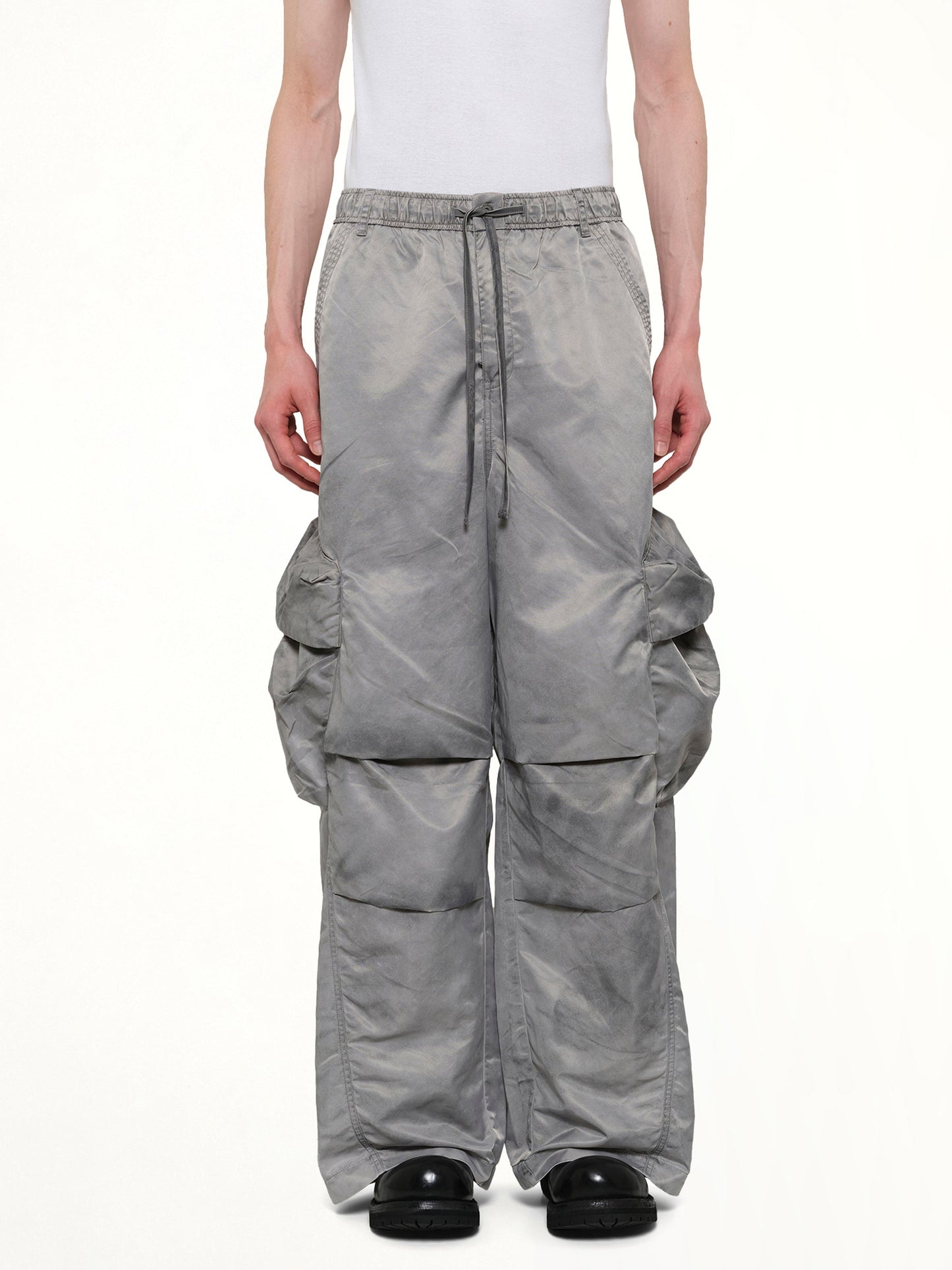 Image of a model wearing Pants. Product name - Sandwashed Nylon Cargos in Grey colour by brand - FENG CHEN WANG