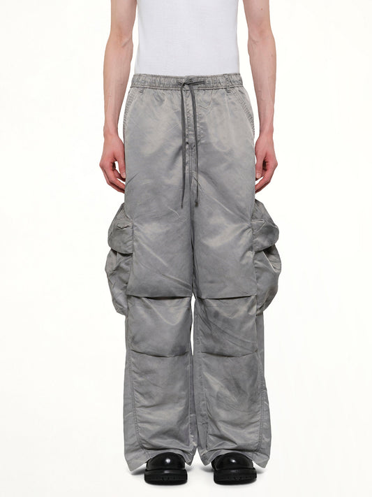 Image of a model wearing Pants. Product name - Sandwashed Nylon Cargos in Grey colour by brand - FENG CHEN WANG