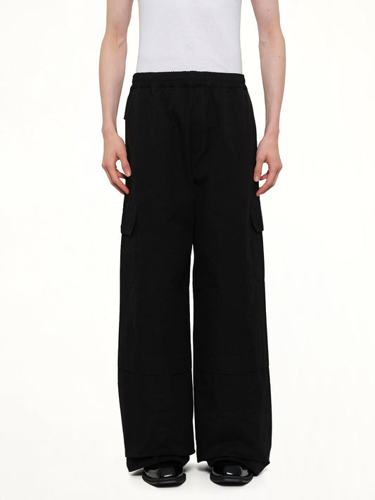 Image of a model wearing Pants. Product name - Sculpted Track Trouser in Black colour by brand - EGONLAB