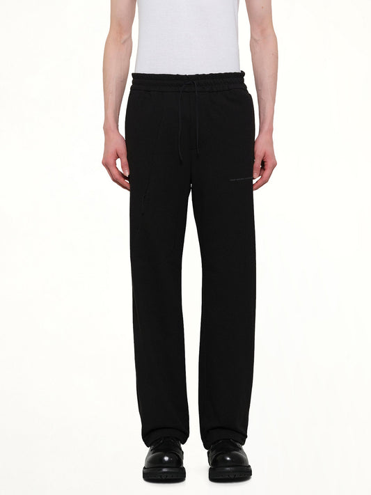 Image of a model wearing Pants. Product name - Work Track Pants (Archive) in Black colour by brand - POST ARCHIVE FACTION