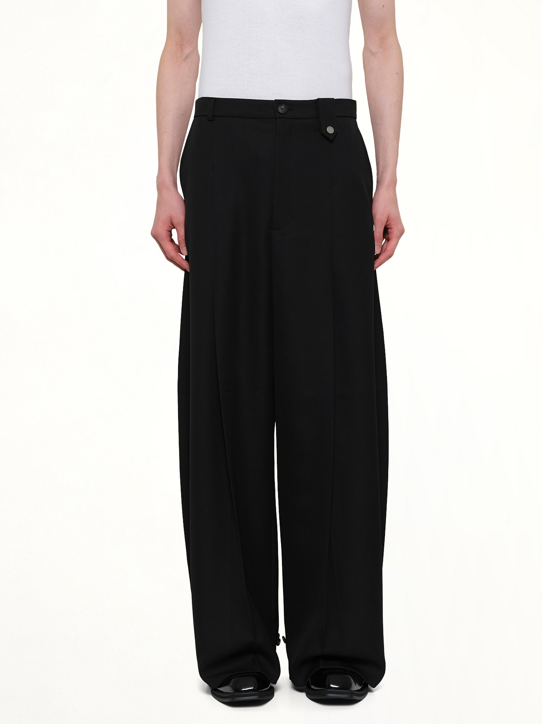 Image of a model wearing Pants. Product name - Fluid Tailored Wide Leg Pants in Black colour by brand - EGONLAB