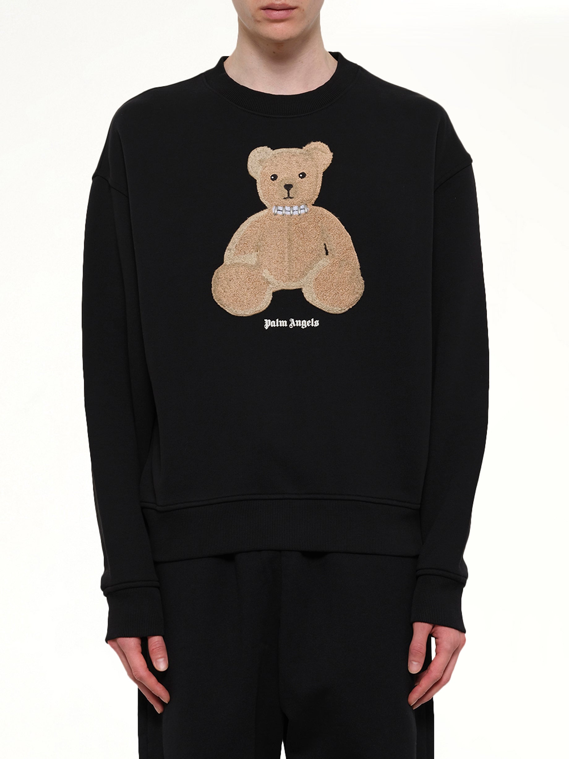Image of a model wearing Outerwear. Product name - Bear Regular Sweatshirt in Black colour by brand - PALM ANGELS