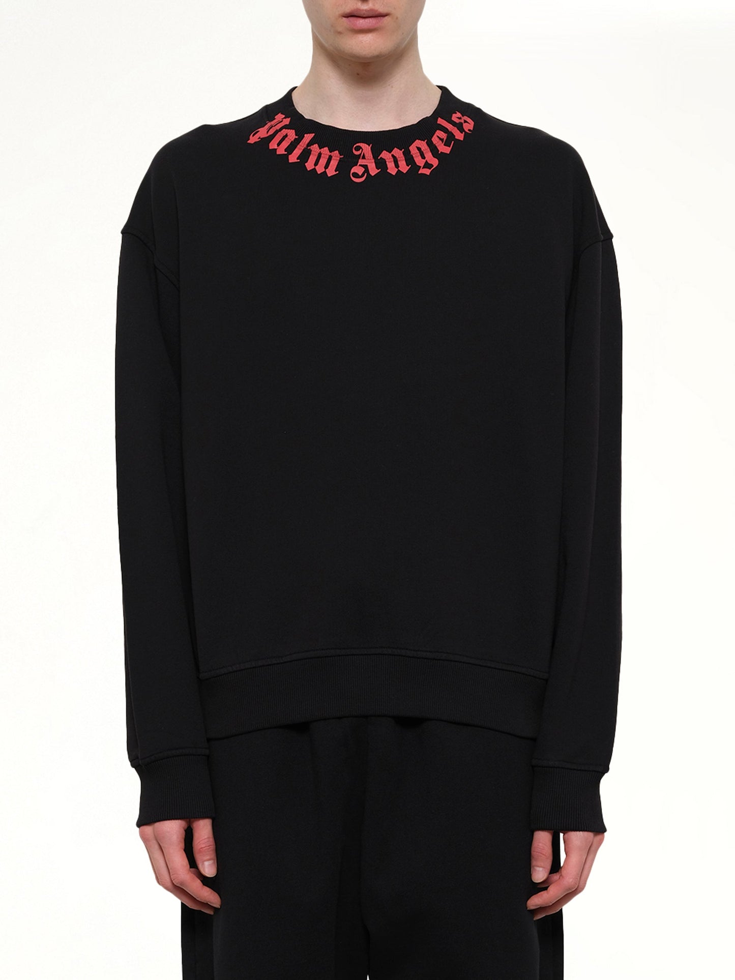 Image of a model wearing Outerwear. Product name - Neck Logo Regular Sweatshirt in Black colour by brand - PALM ANGELS