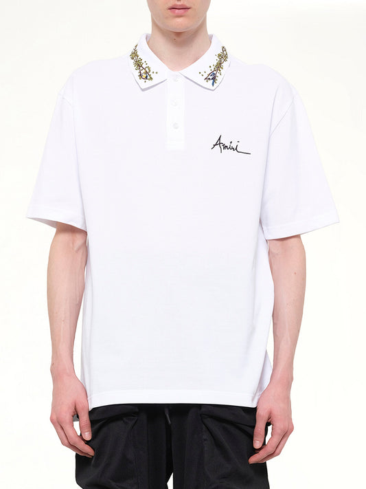 Image of a model wearing Tops. Product name - Amiri Floral Collar Polo in White colour by brand - AMIRI