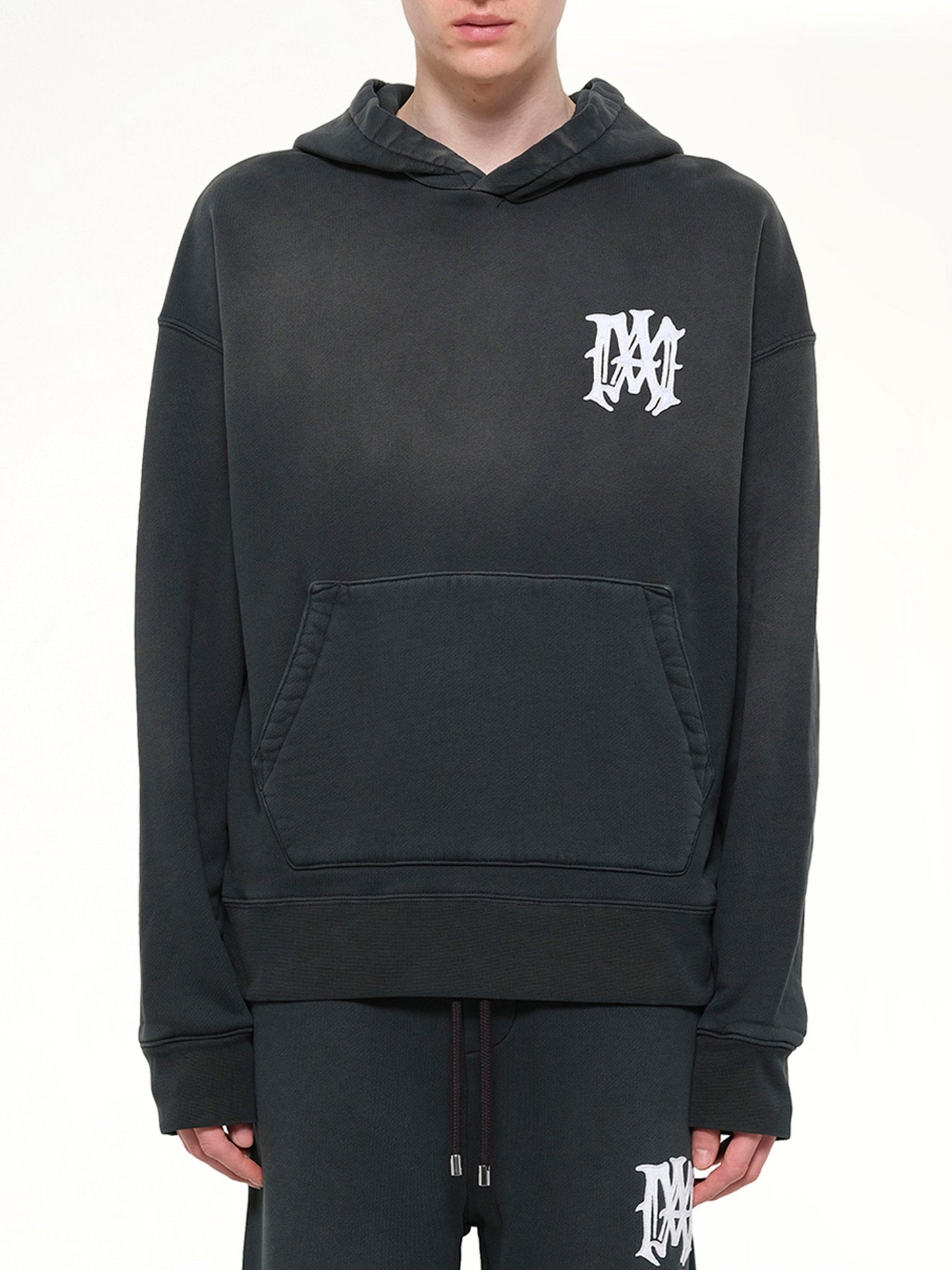 Image of a model wearing Outerwear. Product name - Amiri Hollywood Oversized Hoodie in Black colour by brand - AMIRI