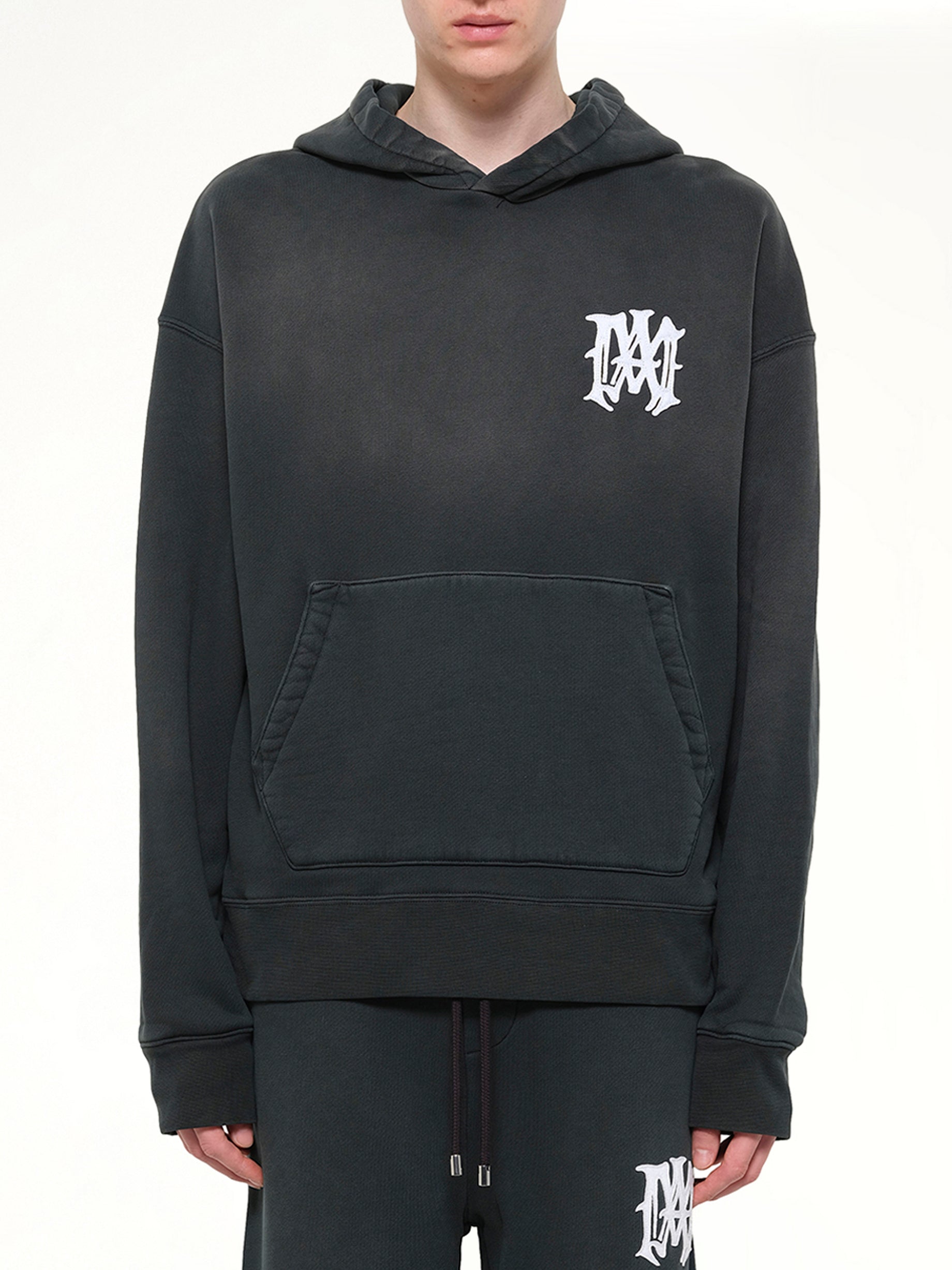 Image of a model wearing Outerwear. Product name - Amiri Hollywood Oversized Hoodie in Black colour by brand - AMIRI