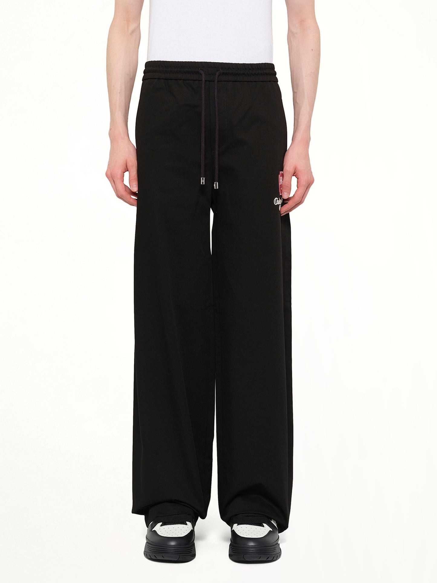 Image of a model wearing Pants. Product name - MA Chateau Pant in Black colour by brand - AMIRI