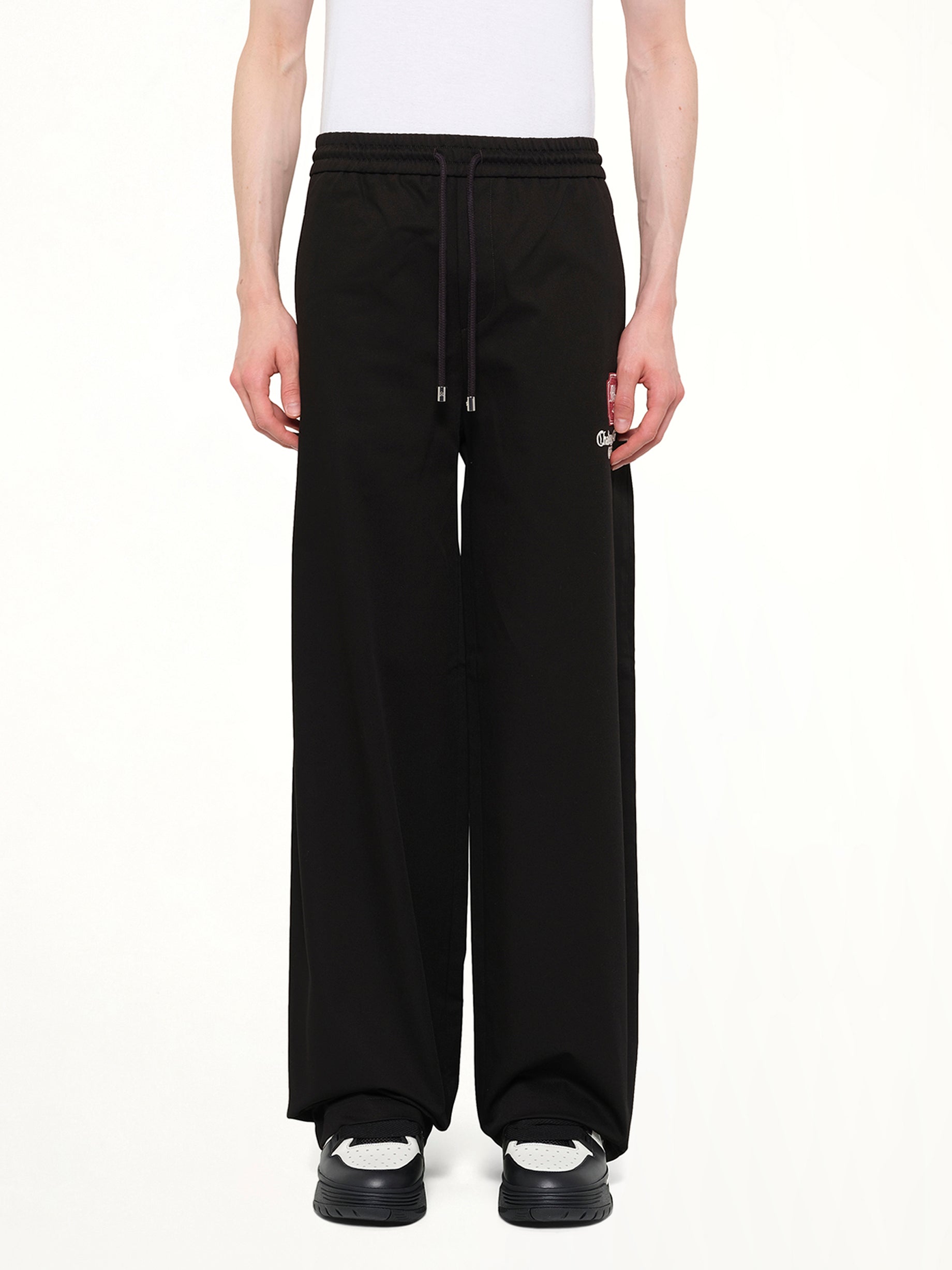 Image of a model wearing Pants. Product name - MA Chateau Pant in Black colour by brand - AMIRI