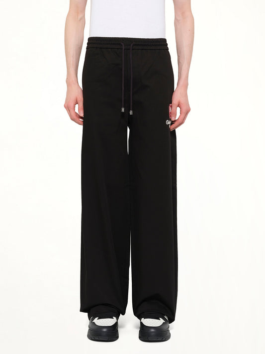 Image of a model wearing Pants. Product name - MA Chateau Pant in Black colour by brand - AMIRI