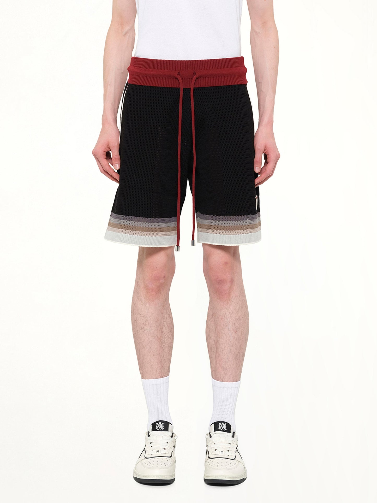 Image of a model wearing Shorts. Product name - MA Sport Shorts in Black colour by brand - AMIRI