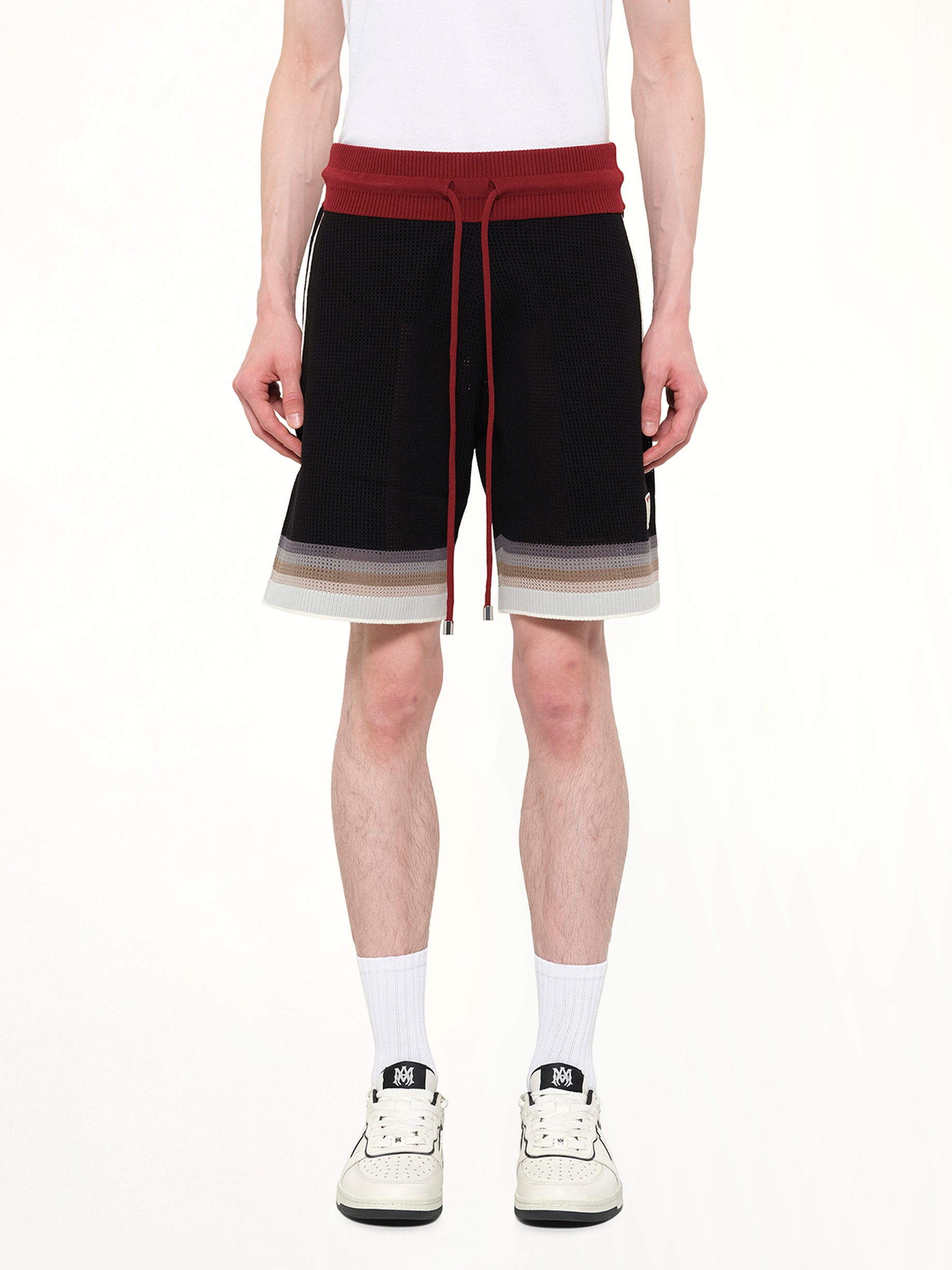 Image of a model wearing Shorts. Product name - MA Sport Shorts in Black colour by brand - AMIRI
