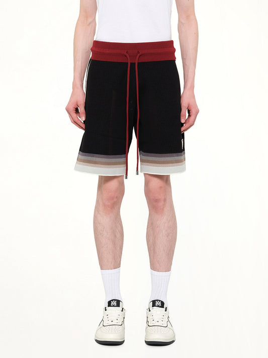 Image of a model wearing Shorts. Product name - MA Sport Shorts in Black colour by brand - AMIRI