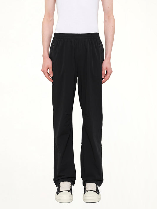 Image of a model wearing Pants. Product name - Team 247 Straight Leg Track Pant in Black colour by brand - REPRESENT